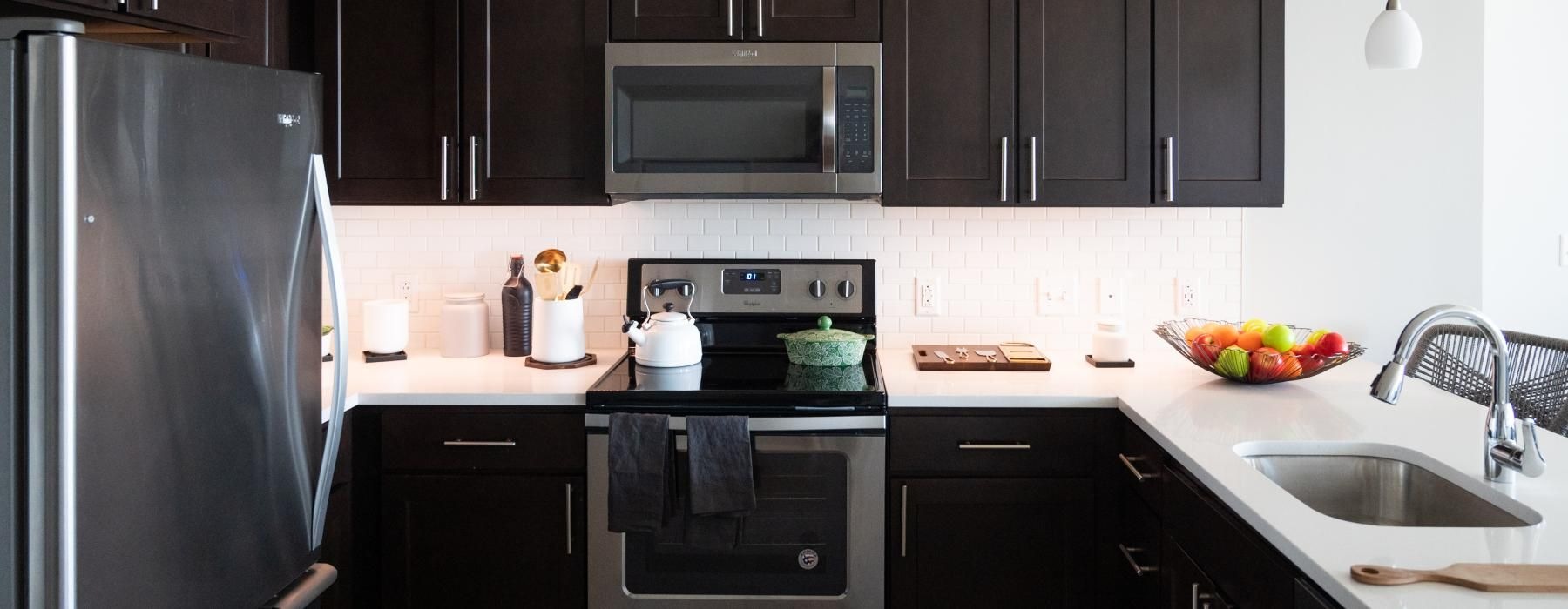 a kitchen with black cabinets